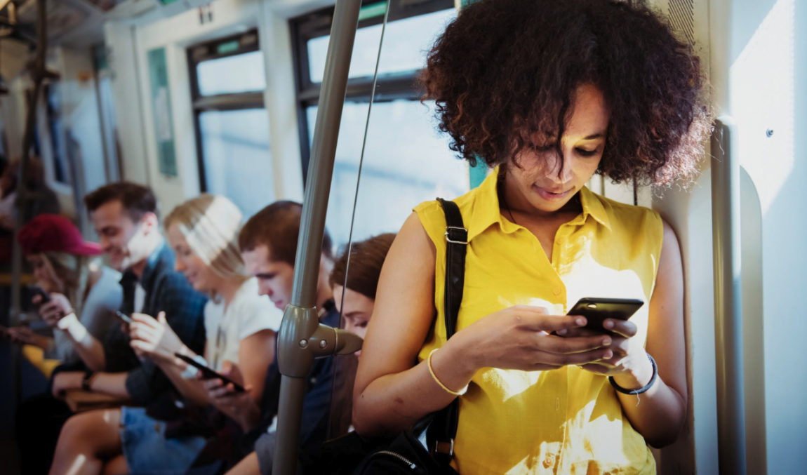 Woman using smartphone on subway